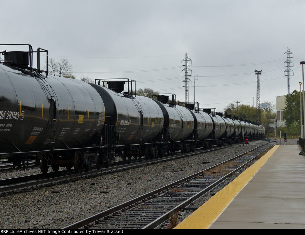 CN locomotives heading up an oil tank train.